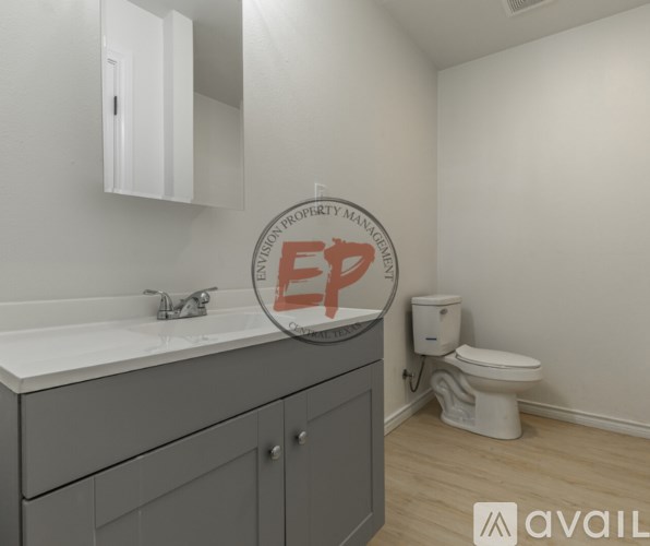 A bathroom with a toilet and a sink.