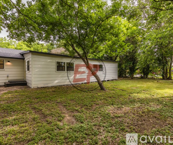 A house with a tree in front of it.
