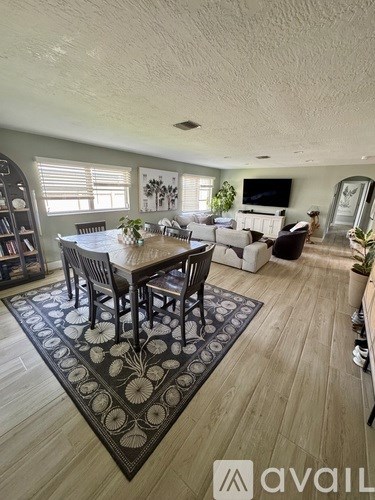 A living room with a dining table and chairs.