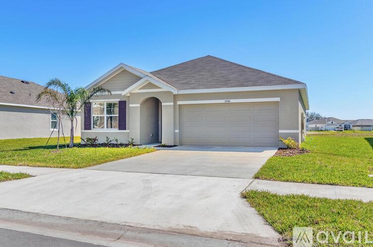 A two-story house with a garage is for sale.