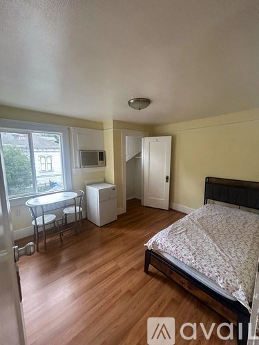A bedroom with a bed, dresser, and window.