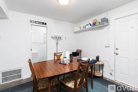 A dining room with a wooden table and chairs.