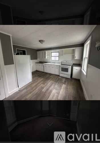 A kitchen with white appliances and wooden floors.