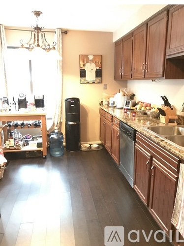 A kitchen with wooden cabinets and a granite countertop.