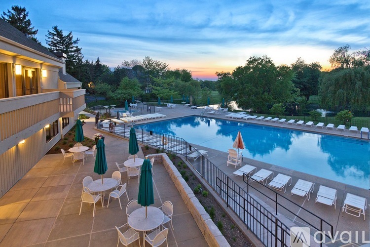 A pool area with chairs and umbrellas is available.