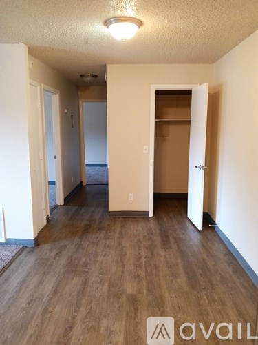 A room with wooden floors and a white ceiling with a light fixture.