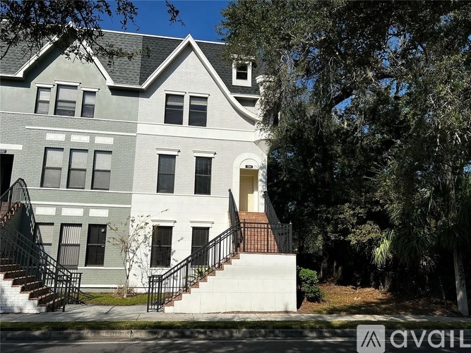 A two-story house with a staircase leading to the front door.