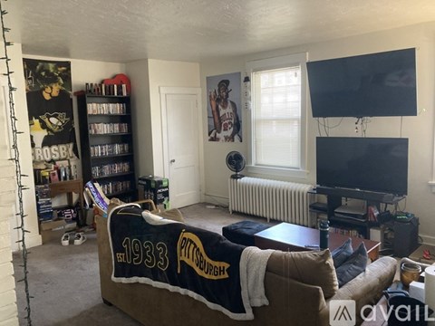 A living room with a couch that has "1933 PITTSBURGH" written on it.