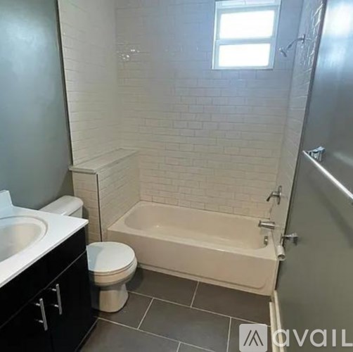 A bathroom with a toilet, sink, and bathtub.