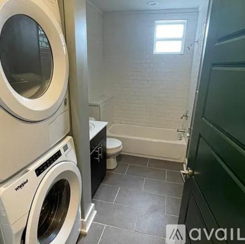 A small laundry room with a washer and dryer.