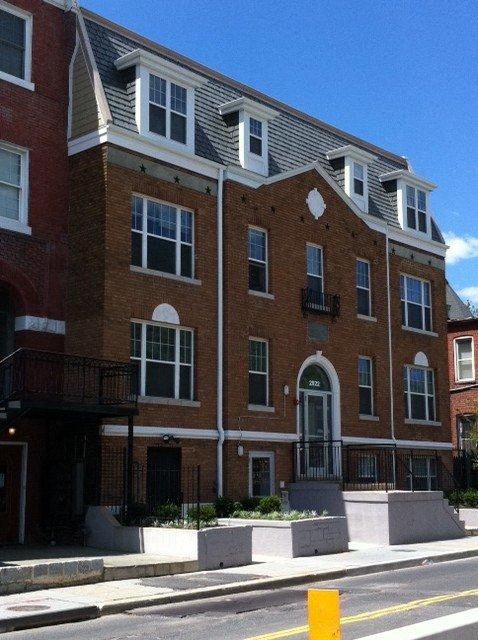 a red brick building on the side of a street
