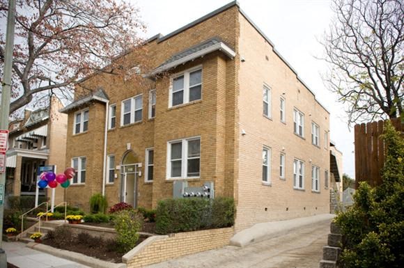 a brick building with balloons in front of it