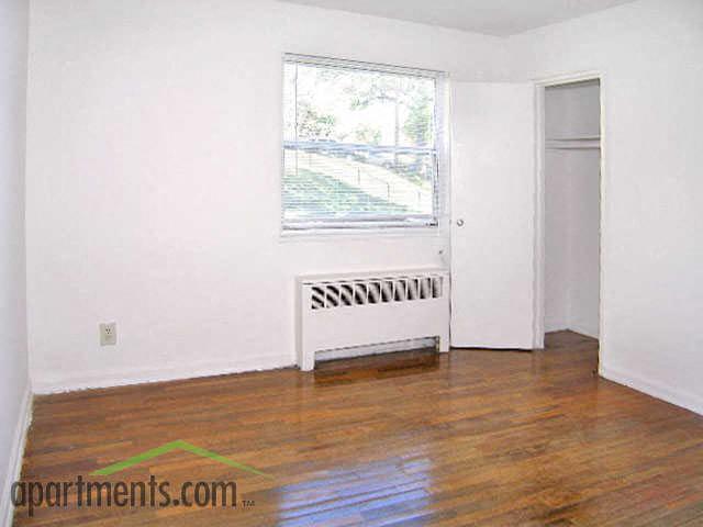 a living room with a wood floor and a window