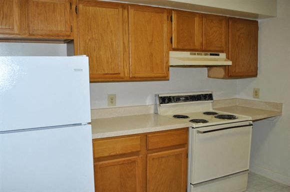 a kitchen with a stove and a refrigerator
