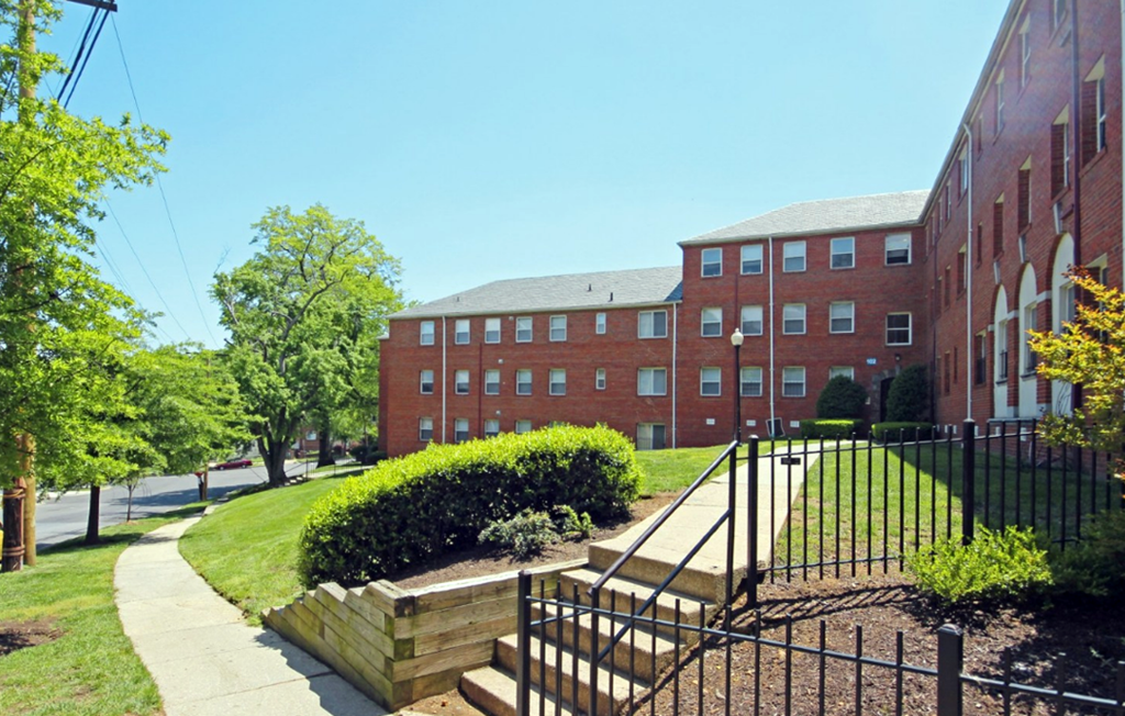 a large brick building with a staircase in front of it