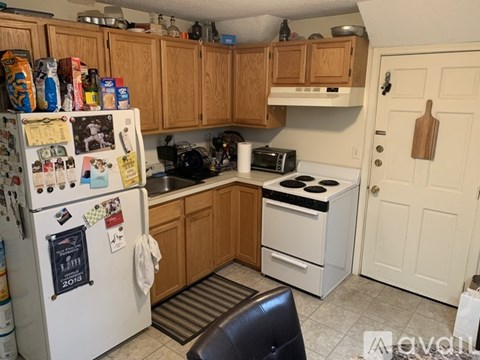 A kitchen with a white fridge and a white stove.