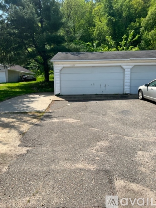A white garage door is on the right side of the image.