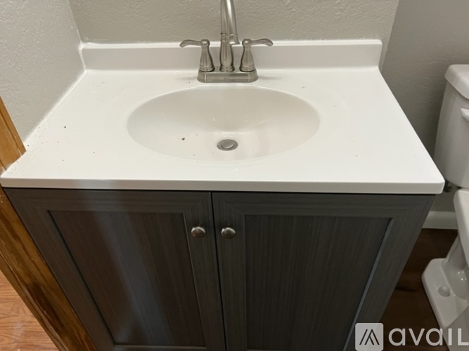 A bathroom sink with a cabinet below it.