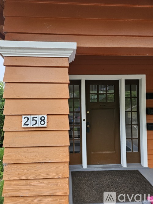 A house numbered 258 with a brown door.