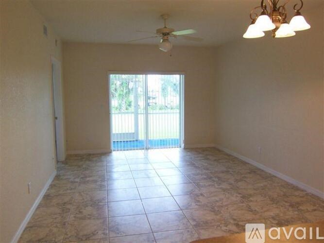 A room with tiled flooring and a ceiling fan.