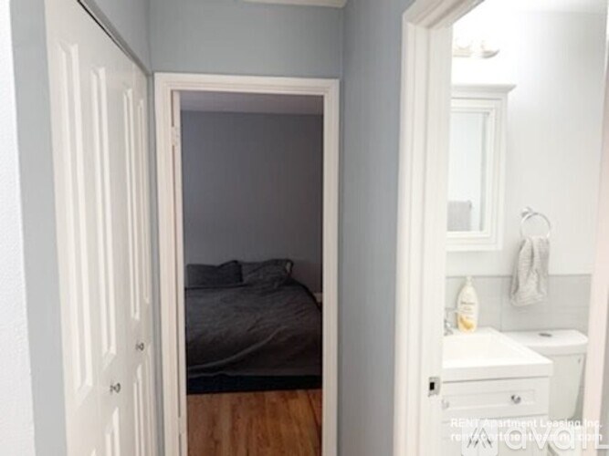 A bedroom with a bed and a toilet.