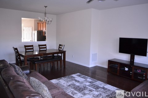 A living room with a brown couch and a television.