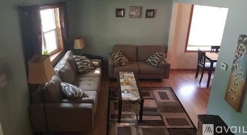 A living room with a brown couch and a coffee table.