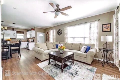 A living room with a beige sofa and a coffee table.