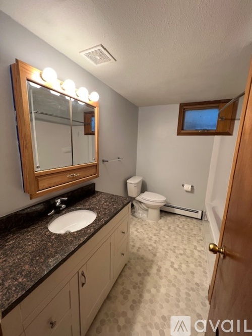 A room with a white door and a brown door with a shelf in between.
