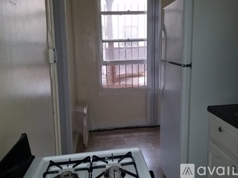 A kitchen with a white fridge and a black stove top.