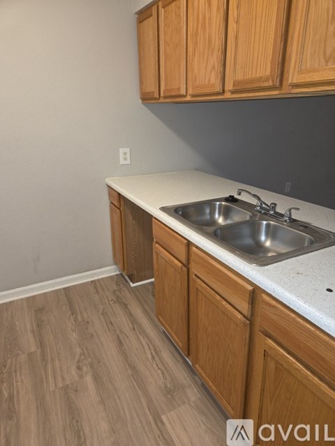 A kitchen with wooden cabinets and a white countertop.