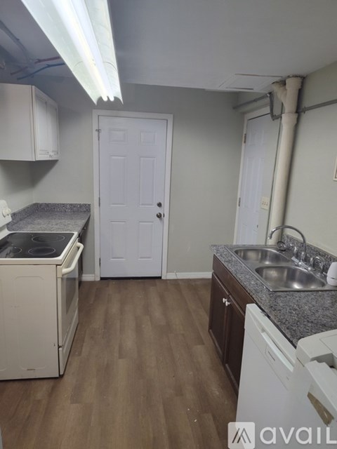 A kitchen with a washing machine and a sink.