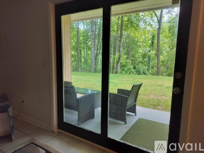A patio with a table and chairs is visible through a glass door.
