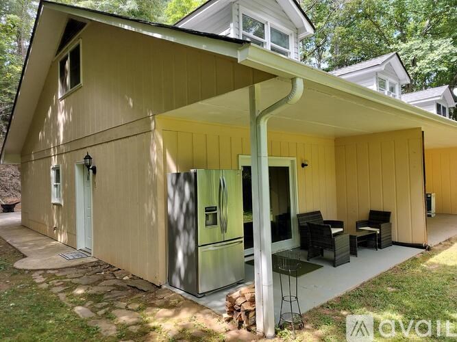 A small house with a porch and a green door.