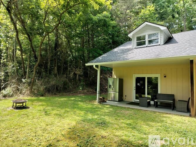 A small house with a porch and a covered patio.