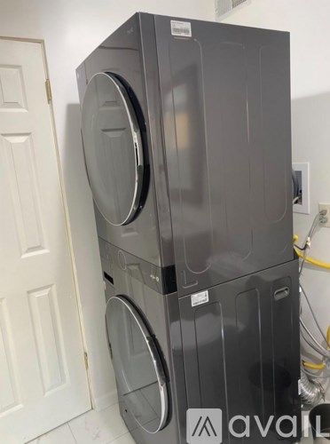 A stack of two front loading washing machines.