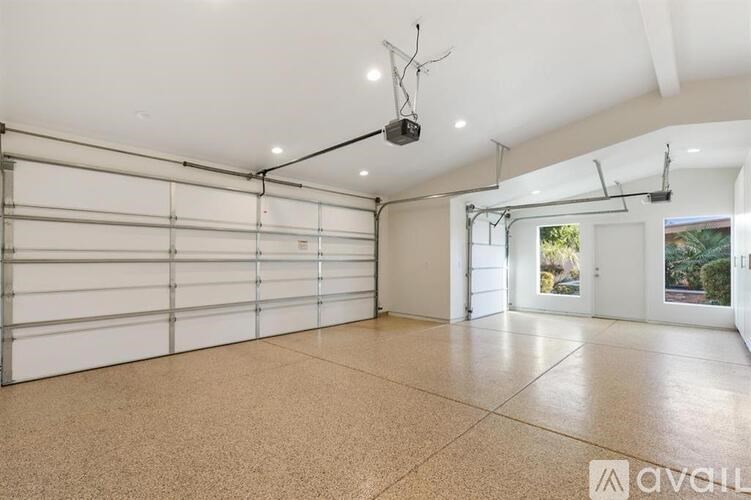 A spacious garage with a white ceiling and a large window.
