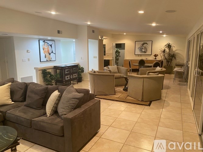 A living room with a couch, a chair, and a coffee table.