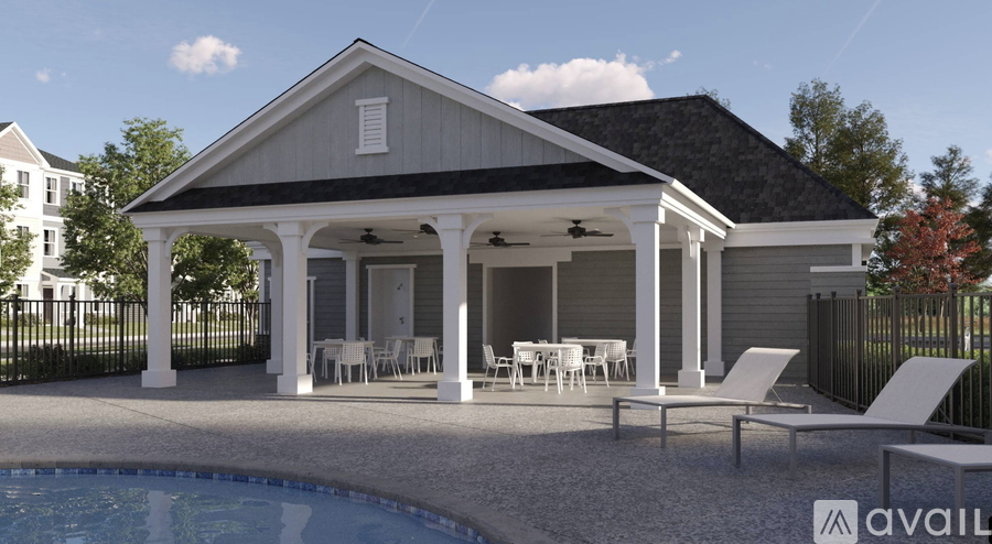 A house with a pool in front of it.
