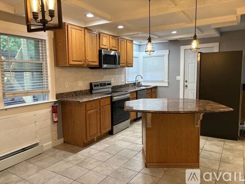A kitchen with wooden cabinets and a granite countertop.