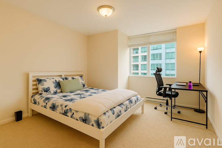 A bedroom with a bed, desk, and chair.