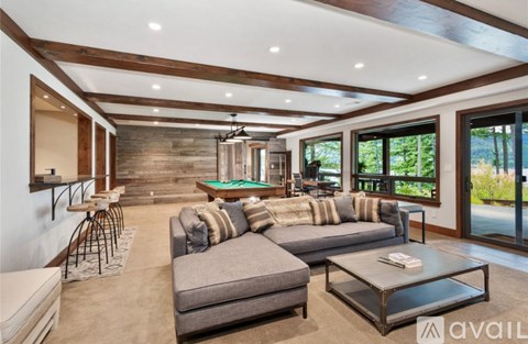 A modern living room with a grey sofa and a coffee table.