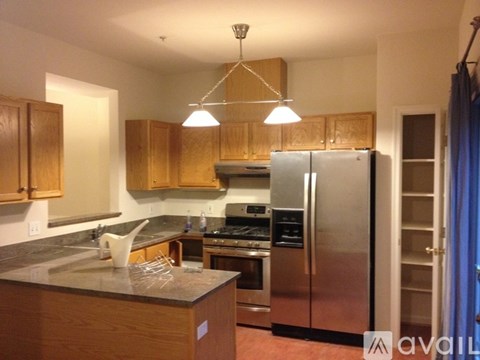 A kitchen with wooden cabinets and stainless steel appliances.
