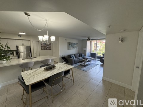 A modern kitchen with a dining table and chairs.