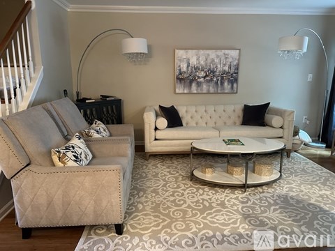A living room with a grey couch and a white couch.