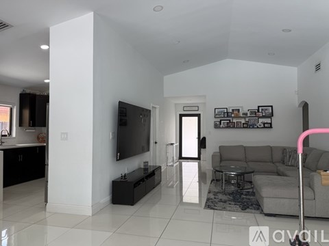 A living room with a grey couch and a television.