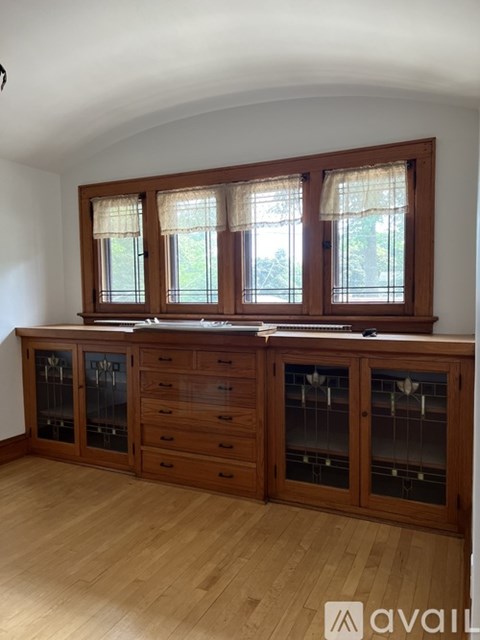 A kitchen with wooden cabinets and a window.