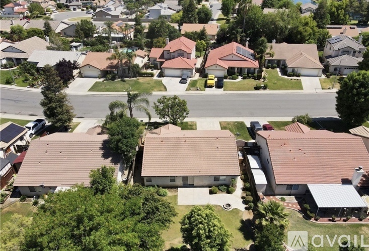 A bird's eye view of a suburban neighborhood with houses and trees.
