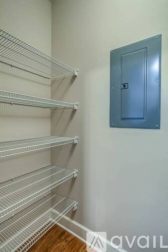 A room with a door and shelves.