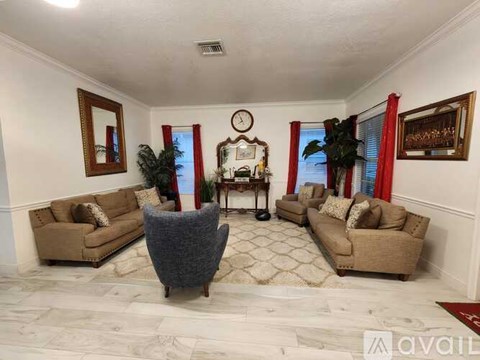 A living room with a grey chair in the middle of the room.